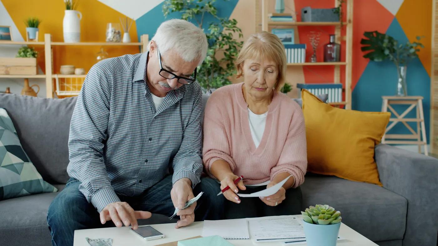 Senior couple reviewing documents at home